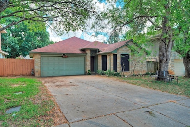 View of front of home featuring driveway, an atta