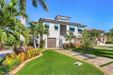 View of front of property with stairs, a front yard, driveway, and an attached garage