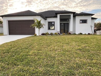 Prairie-style house with a front yard and a garage