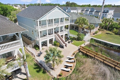 Back of house featuring a balcony, roof with shingles, a residential view, and stucco siding