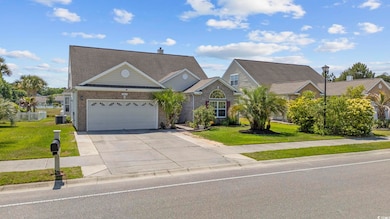 View of front of home featuring concrete driveway, brick siding, a front lawn, and an attached garage