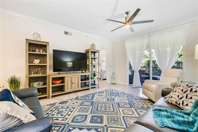 Living room with ceiling fan and crown molding