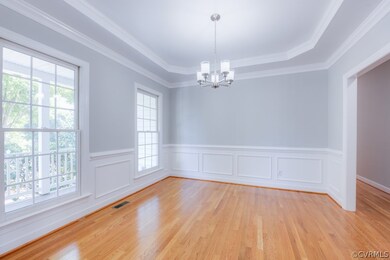 Dining room with gorgeous crown molding and tray c