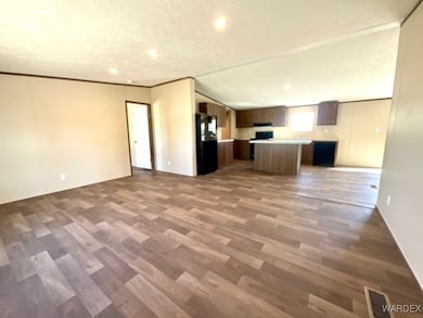 Unfurnished living room featuring hardwood / wood-
