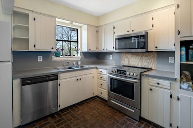 Kitchen with sink, stainless steel appliances, whi