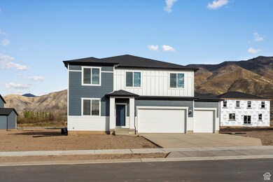 View of front facade featuring a mountain view, concrete driveway, an attached garage, board and batten siding, and a shingled roof