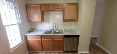 Kitchen featuring brown cabinets, and light countertops