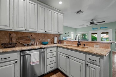 Kitchen featuring stainless steel dishwasher, a p
