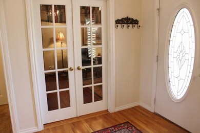 A welcoming entry with real wood floors and French