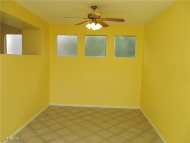 Empty room featuring baseboards and ceiling fan