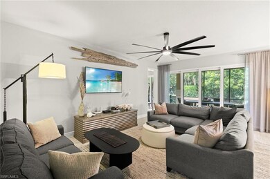 Living area with a ceiling fan and baseboards