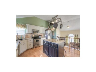 Hardwood floors and pot rack over island