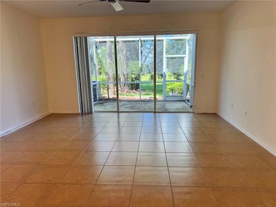 Empty room featuring light tile patterned flooring and a ceiling fan