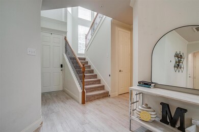 Spacious entrance to home with staircase featuring