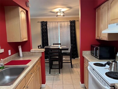 Kitchen with sink, white electric stove, crown mol