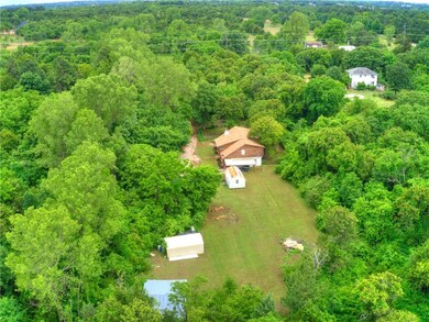 Secluded with 2 outbuildings, a pole barn and 2 carports