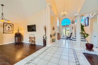Entryway with decorative columns, high vaulted cei