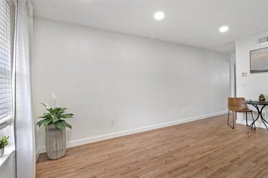 Unfurnished room with light wood-style floors, ba