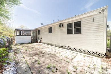 Large back yard patio off of the enclosed porch.
