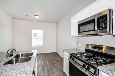 Kitchen with dark wood-type flooring, white cabine