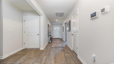 Hallway with hardwood / wood-style flooring