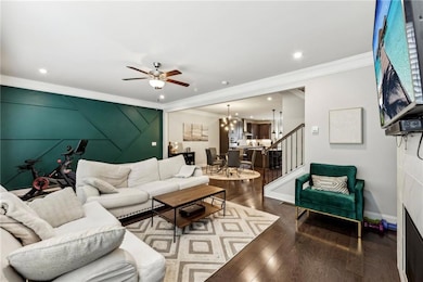 Living area featuring stairway, wood finished floo