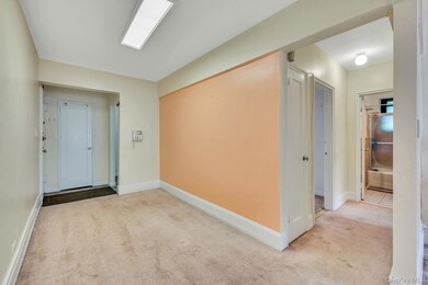 Entryway with carpet and baseboards