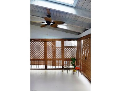 Vaulted ceiling screened-in porch complete with skylights and a paddle fan.  Sun shades can be used for privacy or on those bright summer days!