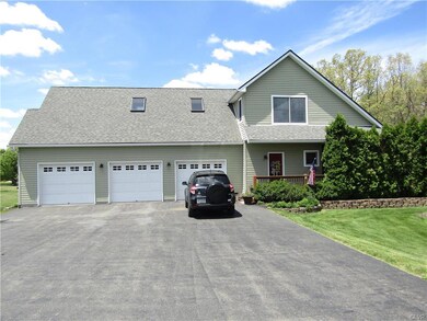 3 CAR ATTACHED GARAGE WITH LARGE PAVED DRIVEWAY