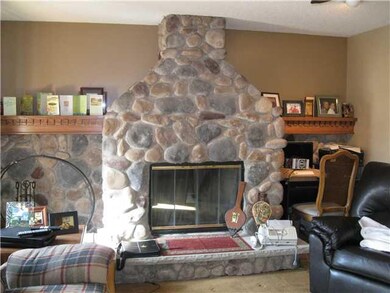Living Room. Stone woodburning fireplace with gas 