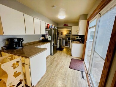 The home has two patios --- one leading out to rear from the kitchen and one leading out from the dining room. Both lead out to a rear concrete patio area and fenced backyard!