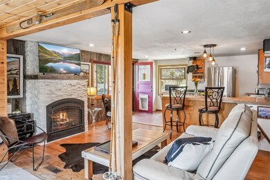 Living room, a fireplace, and wood flooring
