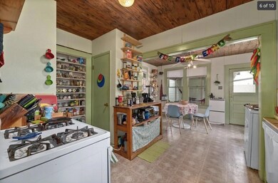 Kitchen featuring white appliances, light floors,