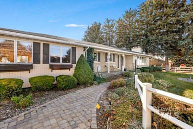 Ranch-style home with a chimney and brick siding