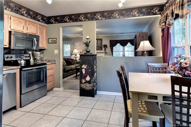 Bright Eat-In Kitchen with stainless appliances an