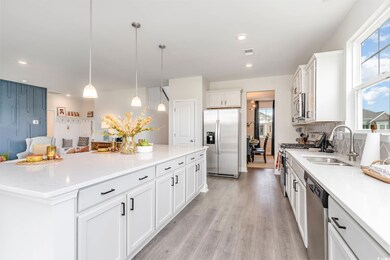 Kitchen featuring appliances with stainless steel finishes, plenty of natural light, white cabinets, and recessed lighting