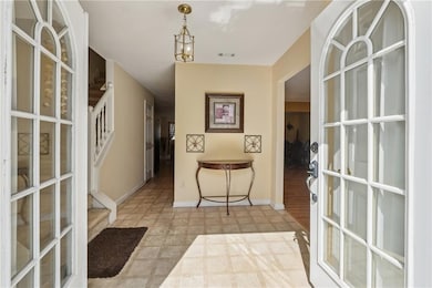 Living area with light wood-style flooring, ceiling fan, a warm lit fireplace, and a textured ceiling