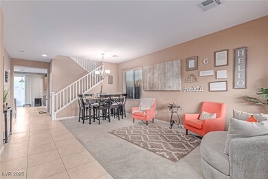 Carpeted living room with stairs, a chandelier, he