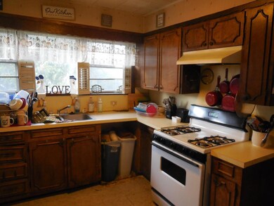 Kitchen with sink and white gas range oven