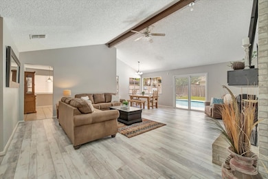 Spacious living area enhanced by dramatic vaulted