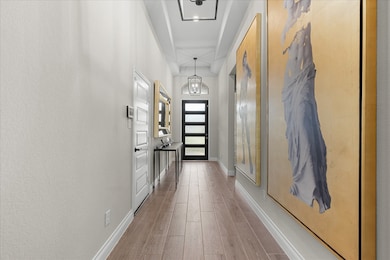 Modern design with light wood flooring, creating an inviting entrance