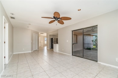 Spare room featuring a ceiling fan, light tile pat