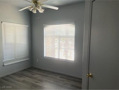 Unfurnished room with ceiling fan, wood finished f