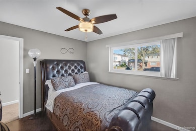 Bedroom featuring baseboards and ceiling fan