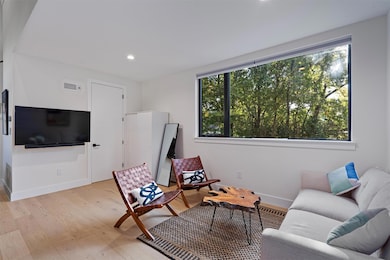 Living area with light wood finished floors, base