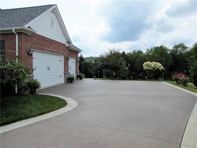 Three car attached garage with exposed aggregate l