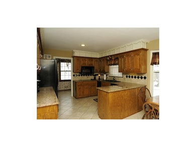 Tile floor, granite and custom back splash.