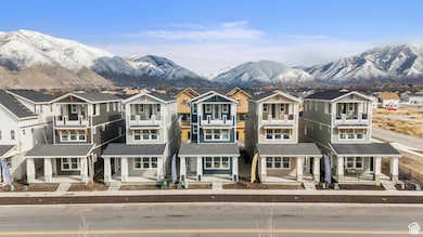 View of front of home with a residential view, a mountain view, and covered porch