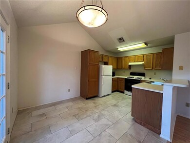 Kitchen with under cabinet range hood, white appl
