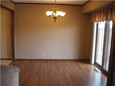 Formal Dining with patio door and wood flooring